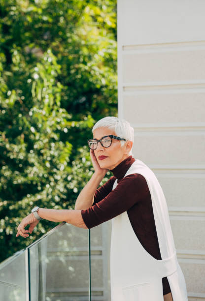 istock Beautiful Senior Woman Standing on a Balcony, Thinking 1327500974