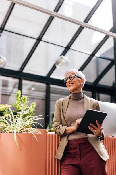 istock Happy Senior Businesswoman Using a Digital Tablet at Work 1327501010