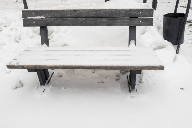 istock Simple wooden bench covered with snow in winter time. 1327501543