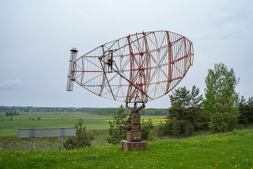 An airport radar on a cloudy sky background. Selective focus.