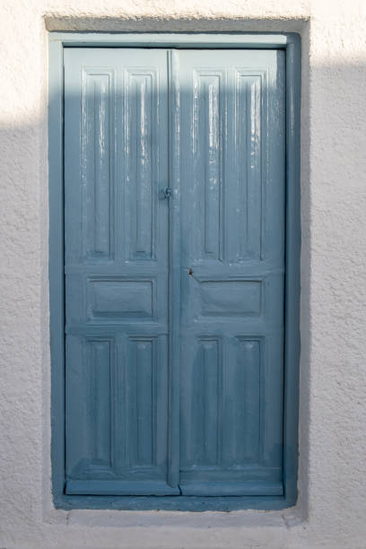 istock Wooden blue color door on a whitewashed wall. Greece, Cyclades. 1327506199
