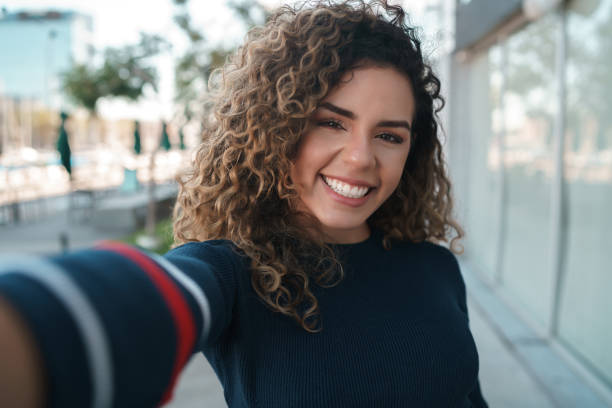 istock Young woman taking selfies outdoors. 1327506372