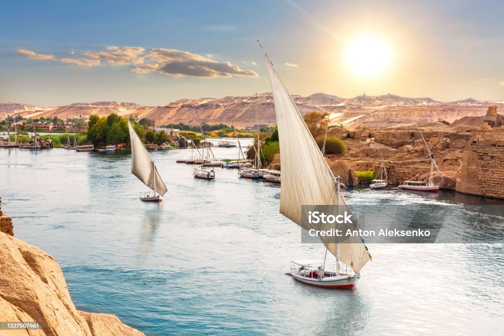 Traditional Nile sailboats near the banks of Aswan, Egypt Traditional Nile sailboats near the banks of Aswan, Egypt. Egypt Stock Photo