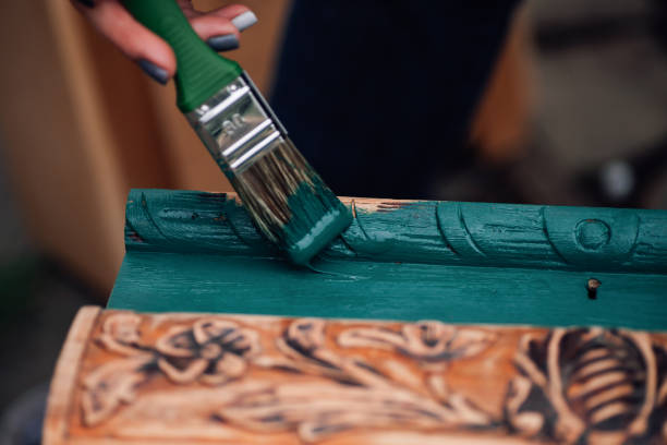 istock macro on a brush in paint and the process of refreshing an old box with monograms, restoring antique objects and moderate consumption 1327507472