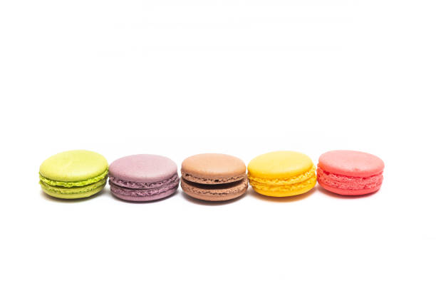 istock Various flavors of pastel macarons stacked against isolated on white background. 1327508385