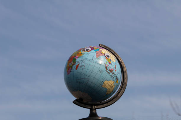 istock Bright globe with toy eyes looking up 1327508719
