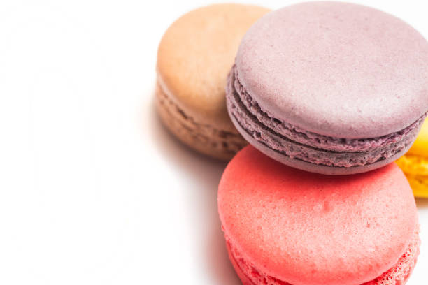 istock Various flavors of pastel macarons stacked against isolated on white background. 1327509680