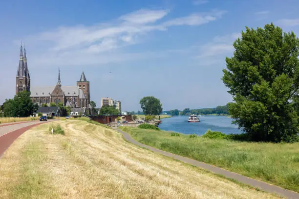 Dutch village Cuijk along river Meuse with view at historic Martinus church