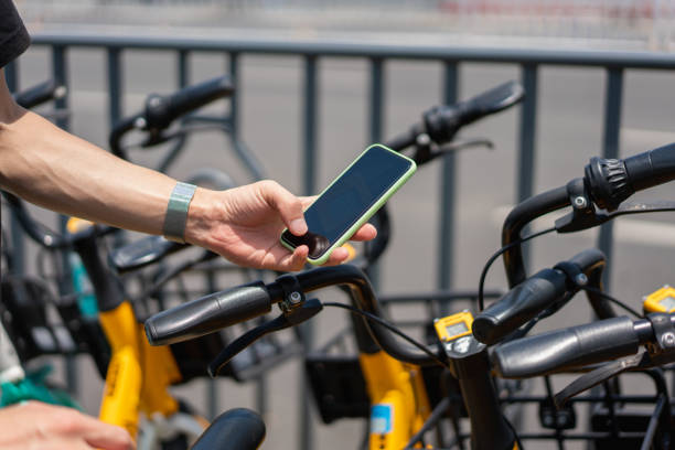 istock One hand is scanning the QR code with a smartphone to unlock the shared bicycle 1327515213