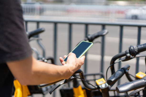 istock One hand is scanning the QR code with a smartphone to unlock the shared bicycle 1327515298