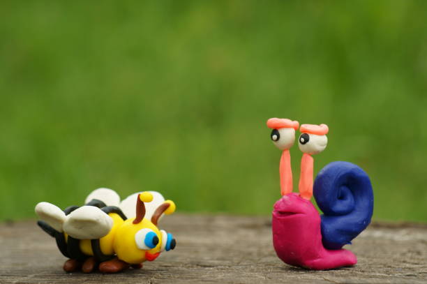 istock Figure of a snail and a bee close-up. 1327517551