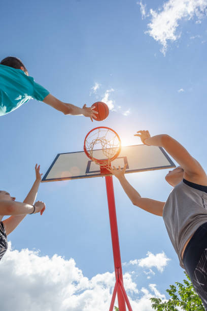 istock Friends playing basketball game on a sunny day 1327517655
