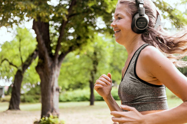istock Female jogger running outdoors for her workout listening music 1327517825
