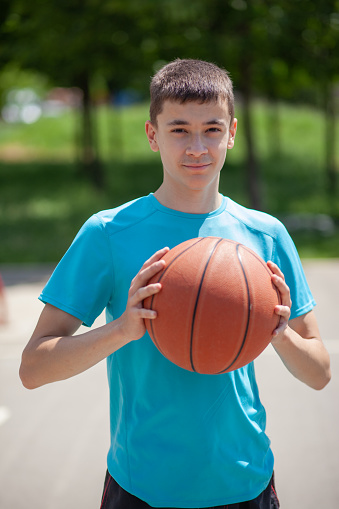 Basketball player posing and playing basketball