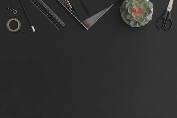 istock Black leather office table with notebook, stationery and green plant. Top view with copy space. Flat lay composition. 1327523566