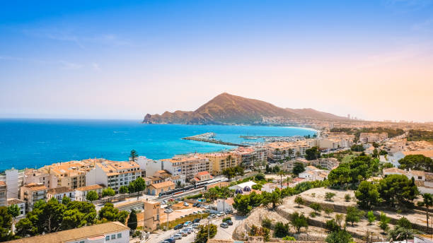 Altea, Spain - beautiful small town with beach, harbour, train and mountains at sunset. Popular Spanish tourist destination in Costa Blanca region on Mediterranean sea