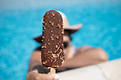 Eating an chocolate ice-cream at the pool.