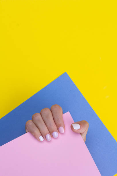 istock Bright purple manicure on multicolor background. 1327525238