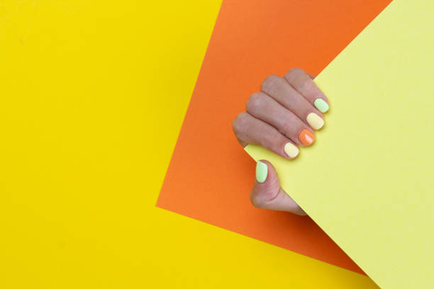 istock Bright colorful manicure on yellow and mint background. 1327525861