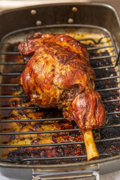 istock Roasting pan with cooked whole leg of lamb 1327530132
