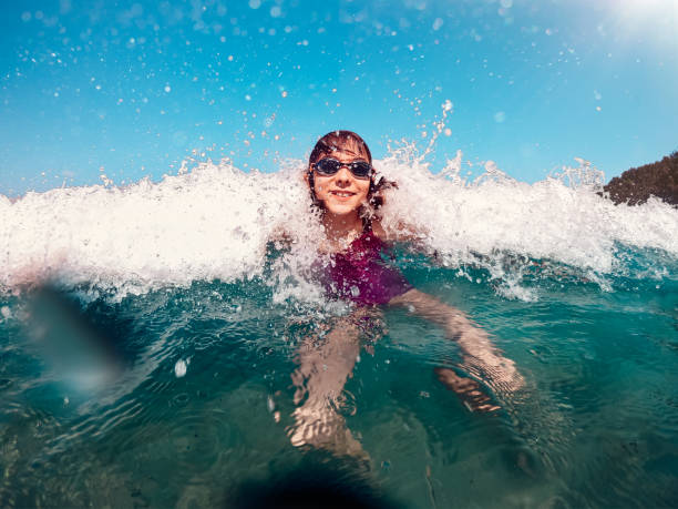istock Girl having fun on the beach 1327530177
