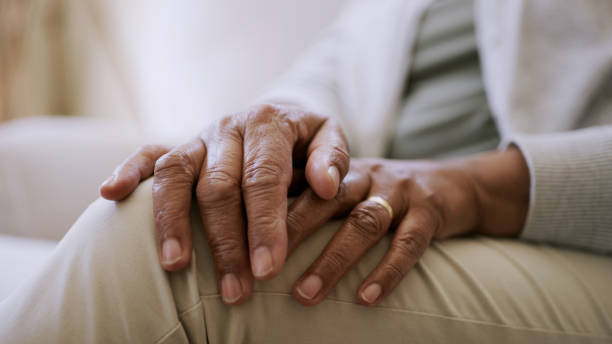 istock of a senior woman's hands while sitting at home 1327531499