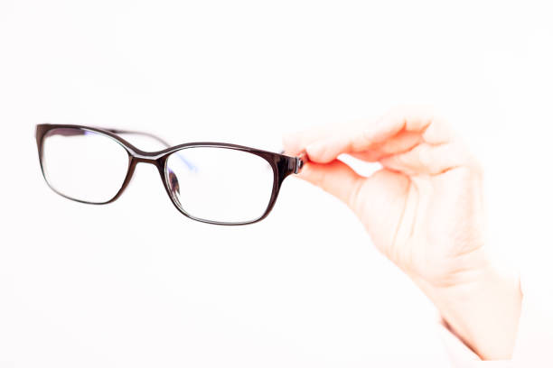 istock glasses in women's hands close-up, white background 1327531765