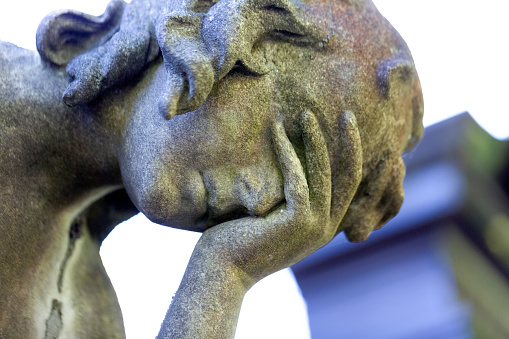 Face of Angel l, statue of angle in cemetery build in 1877 Czech Republic, background with copy space, horizontal composition