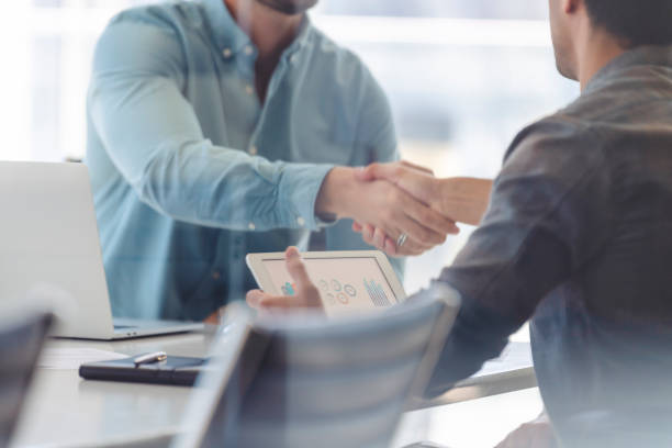 istock Close up of two Businessmen shaking hands. 1327533625