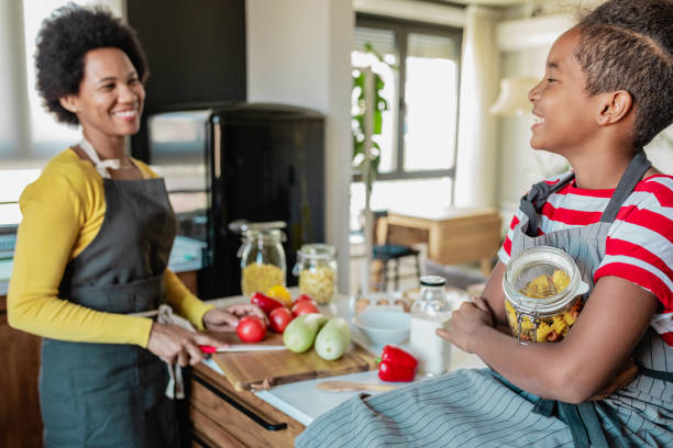 istock Daughter spends time with her mother and helps her in the kitchen 1327533933