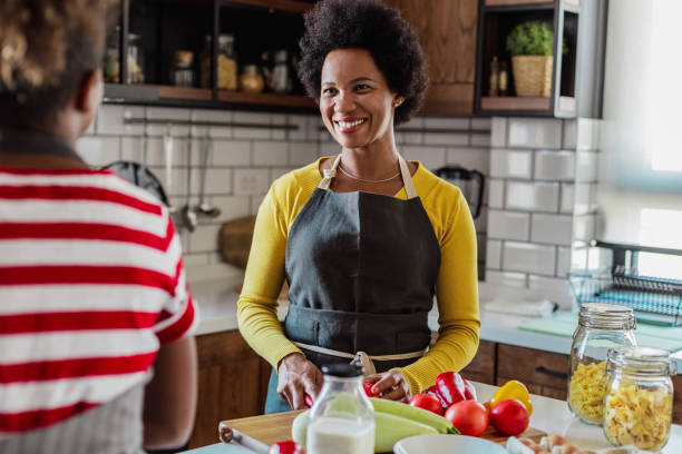 istock Daughter spends time with her mother and helps her in the kitchen 1327534565