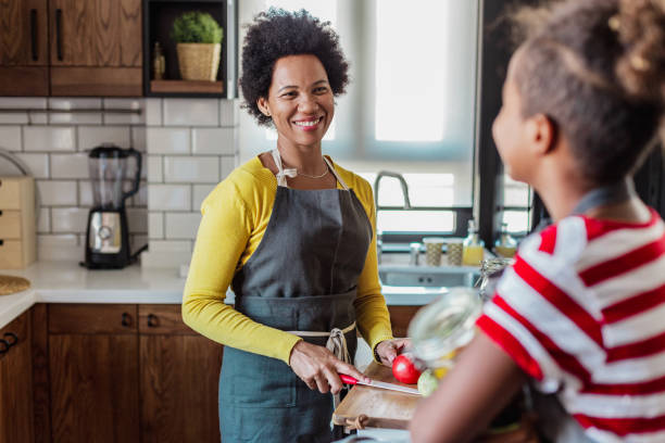 istock Daughter spends time with her mother and helps her in the kitchen 1327534577