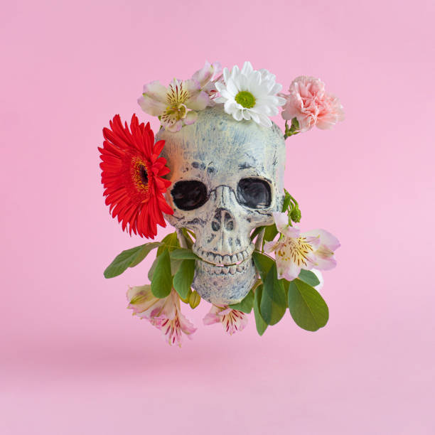 istock Skull with colorful flowers on pink background. Atmosphere witch ritual. Halloween creative fashion love concept. 1327535567