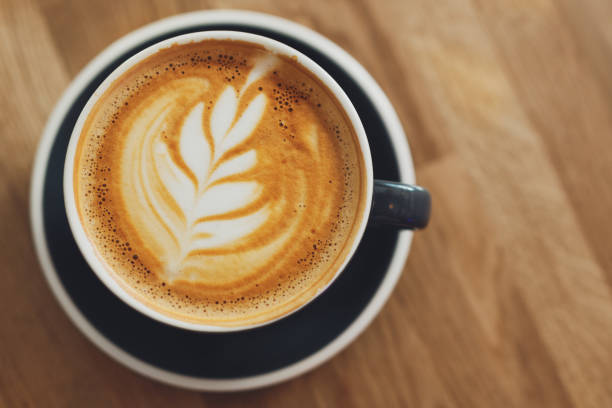 istock Tasty cappuccino in cup on wooden table 1327535911