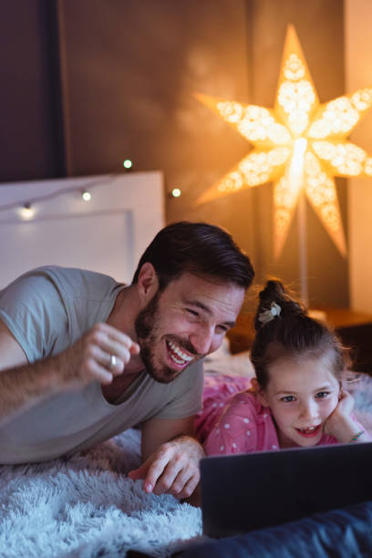 istock Father and daughter looking at laptop cheering 1327537002