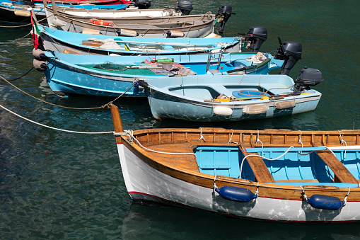 Old wooden fishing boats in the small harbor of Manarola, Cinque Terre, Liguria, Italy.