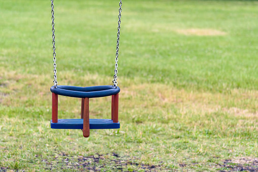 Empty swing with chains on the playground