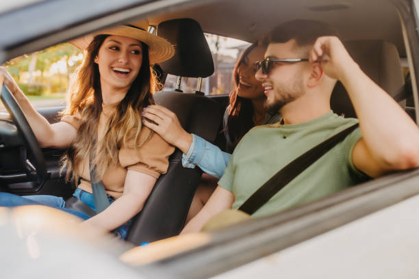 istock happy friends traveling by car 1327545562
