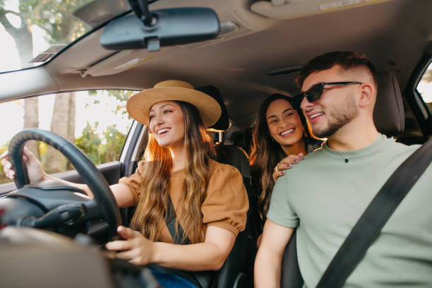 istock happy friends traveling by car 1327546068