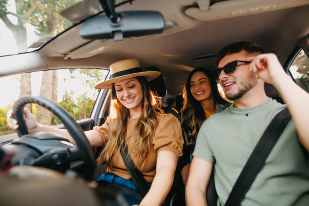 istock happy friends traveling by car 1327546077