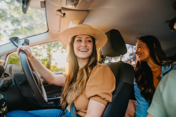 istock happy friends traveling by car 1327546094