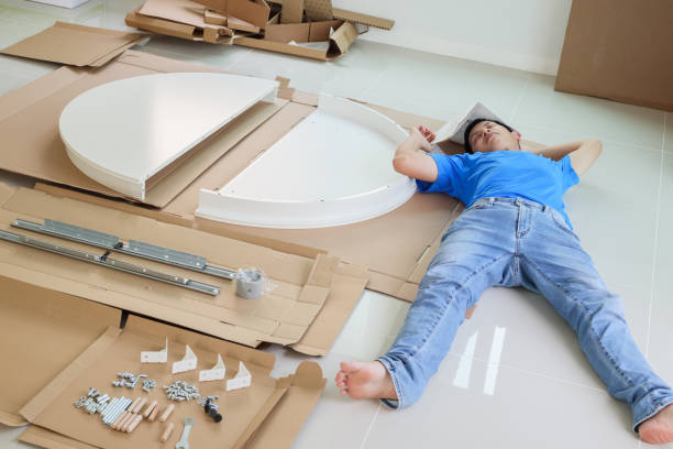 istock Man assembling white round table furniture at home 1327548383