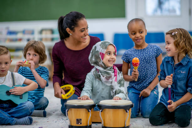 istock Kids playing music in preschool 1327548724
