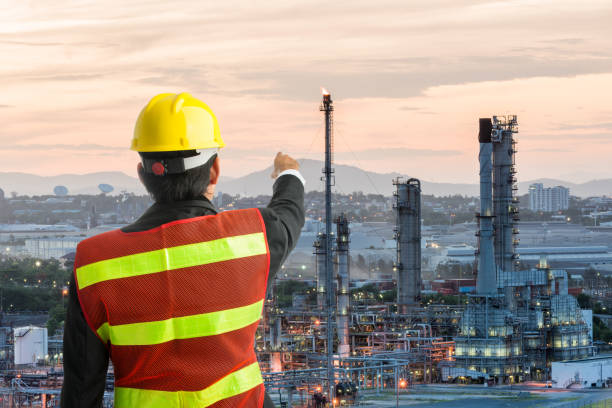 istock Petrochemical engineering man with white safety helmet standing 1327551159