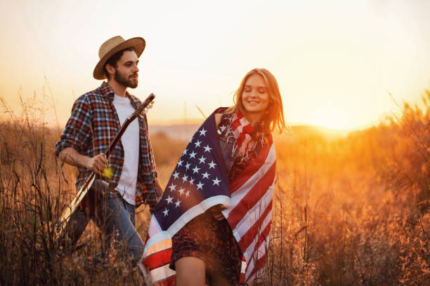 istock Young couple walking on the field during a sunset 1327551463