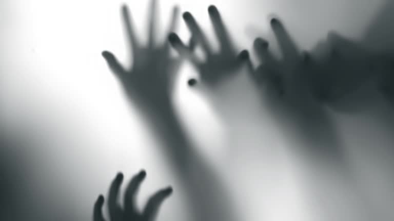 Silhouette of a zombie hand on white background