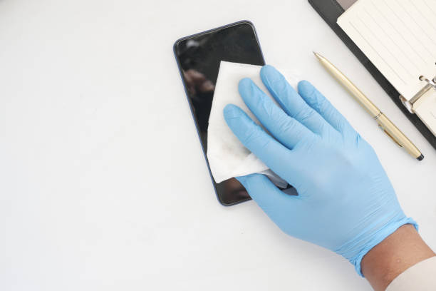 istock cleaning mobile phone display for preventing virus on table 1327562512