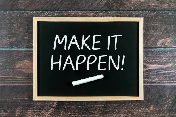 istock Make It Happen words on a blackboard with wooden background. 1327566208