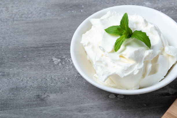 istock Bowl with fresh cottage cheese on a wooden table 1327572122