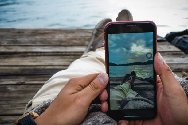 istock Man hands taking a picture of the sunset 1327572908
